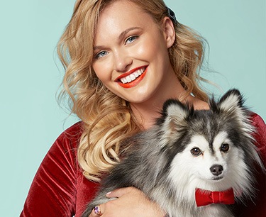 Young woman holding a dog